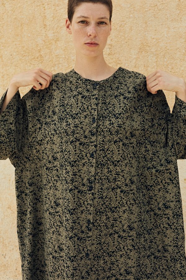 close up view of the model wearing the artist dress in forest color